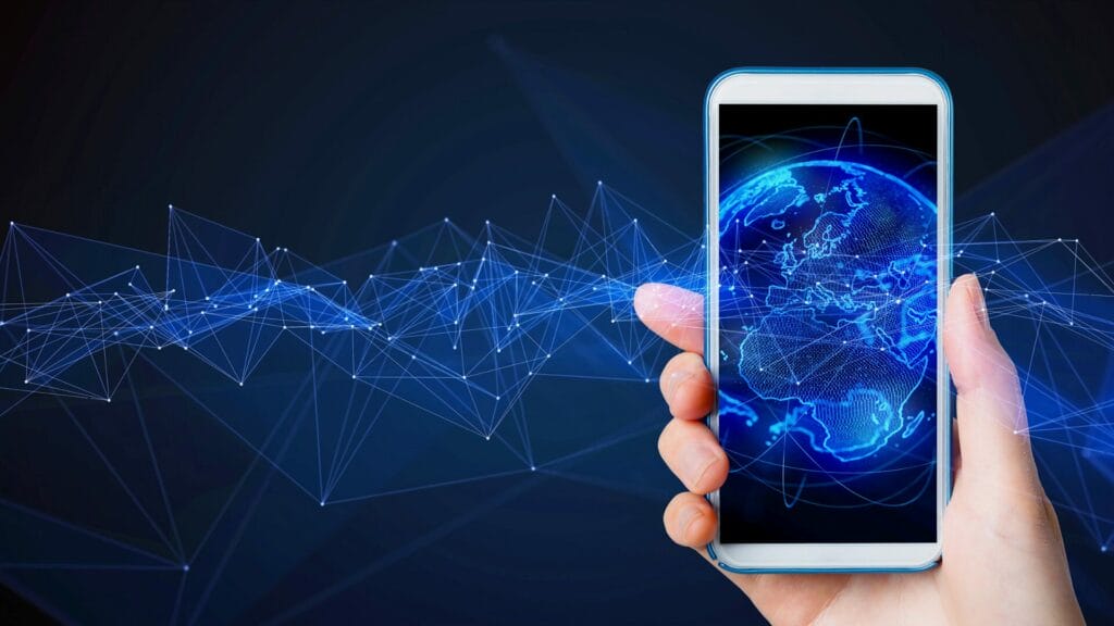 Hand holding a smartphone displaying a digital Earth, with interconnected lines symbolizing global mobile connectivity and international market expansion.