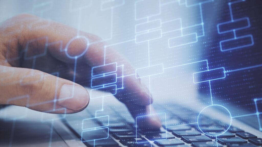 A person's hand typing on a laptop keyboard, overlaid with a digital flowchart representing workflows and processes, symbolizing automation and technology in translation tools.